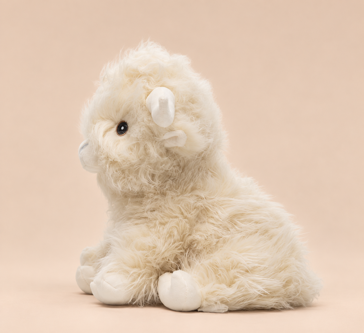 Side view of White Highland Cow weighted stuffed animal by Hugglz